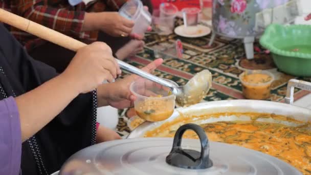 在印度尼西亚塔拉坎分发Asyura粥的Tidung部落妇女 向印度尼西亚塔拉坎的Muharram人民分发传统的Asyura粥 — 图库视频影像