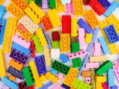 Beyaz arkaplanda izole edilmiş renkli plastik oyuncak blokları.