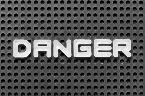 White Alphabet Letter Word Danger Black Pegboard Background — Stock Photo, Image