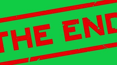Grunge red the end word square rubber seal stamp zoom on green background