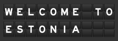 Black color analog flip board with word welcome to estonia on gray background