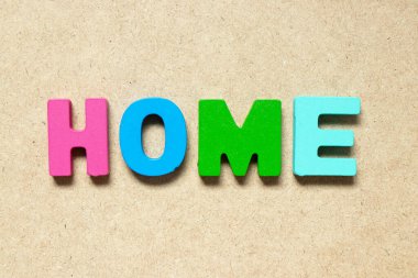 Color alphabet letter in word home on wood background