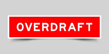 Red color square label sticker with word overdraft on gray background