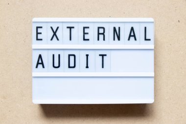 Lightbox with word external audit on wood background