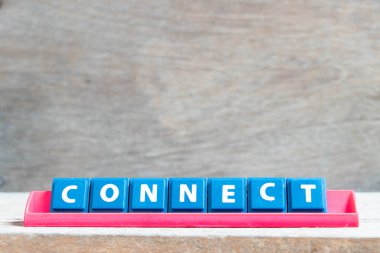 Tile alphabet letter with word connect in red color rack on wood background