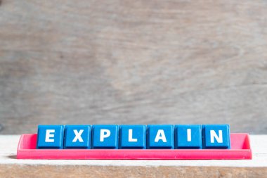 Tile alphabet letter with word explain in red color rack on wood background