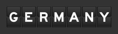 Black color analog flip board with word germany on gray background