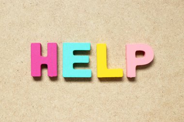 Color alphabet letter in word help on wood background