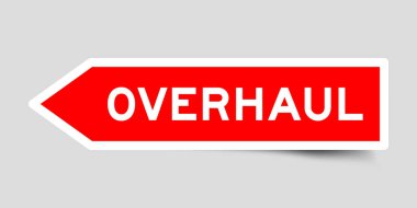Red color arrow shape sticker label with word overhaul on gray background