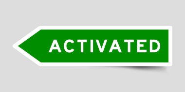 Green color arrow shape sticker label with word activated on gray background