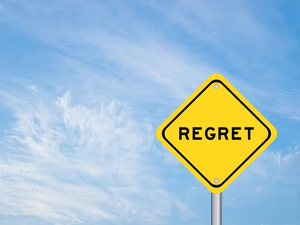 stock image Yellow transportation sign with word regret on blue sky background