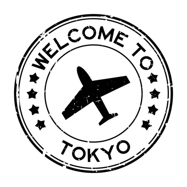 Grunge Noir Bienvenue Mot Tokyo Avec Icône Avion Tampon Joint — Image vectorielle