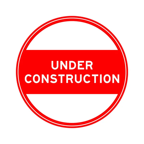 白い背景の上に建設中の言葉で赤い色の丸シールステッカー — ストックベクタ
