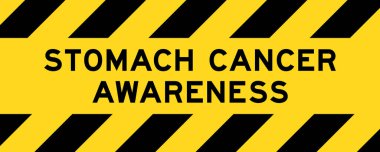 Sarı ve siyah çizgili etiket pankartı ile mide kanseri farkındalığı