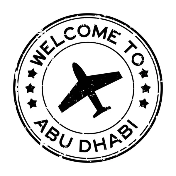 白を背景に飛行機のアイコンの丸いゴムシールスタンプとAbu DabiへのGrunge黒歓迎 — ストックベクタ