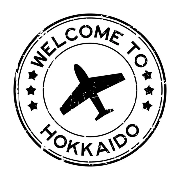 Grunge Svart Välkommen Till Hokkaido Med Flygplan Ikon Rund Gummi — Stock vektor