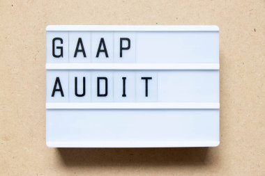 Lightbox with word GAAP (Abbreviation of Generally accepted accounting principles) audit on wood background
