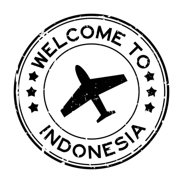 白を背景に飛行機のアイコン丸ゴムシールスタンプでインドネシアへようこそグランジ黒 — ストックベクタ