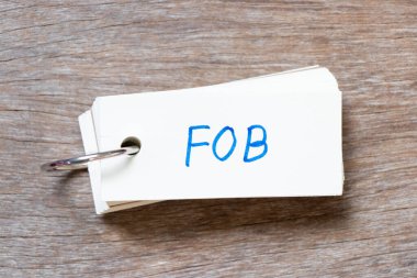 Tahta zemin üzerinde FOB ile yazılmış el yazısı olan flaş kart (tahtada Ücretsiz 'in kısaltılmışı)