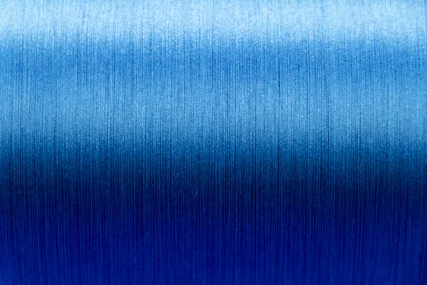 Closed up of blue color of thread textured background (Focus at center of picture)