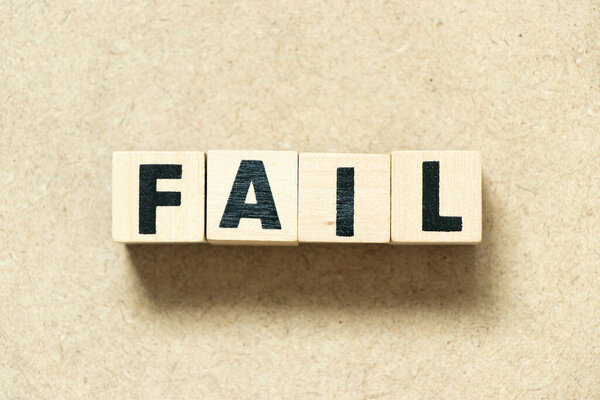 Alphabet letter block in word fail on wood background