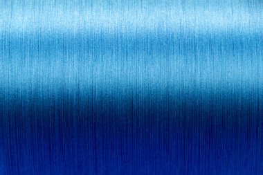 Closed up of blue color of thread textured background (Focus at center of picture)