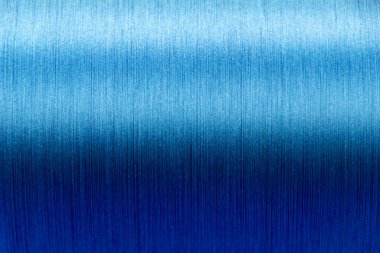 Closed up of blue color of thread textured background (Focus at center of picture)