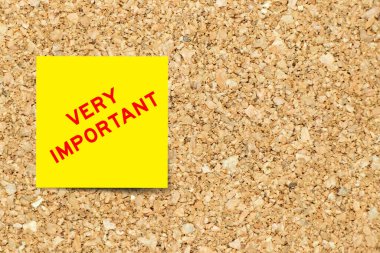 Kelime içeren sarı not kağıdı mantar kaplama arka planında kopya alanı ile çok önemlidir