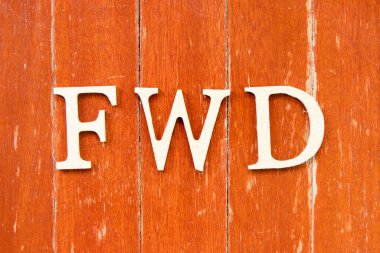 Alphabet letter in word FWD (Abbreviation of forward) on old red color wood plate background clipart