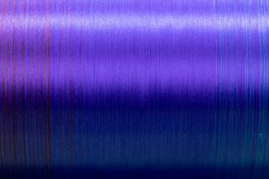Closed up of violet color of thread textured background (Focus at center of picture)