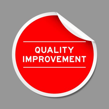 Red color peel sticker label with word quality improvement on gray background clipart