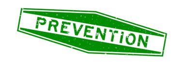 Grunge yeşil önleme sözcüğü altıgen lastik mühür beyaz arka planda