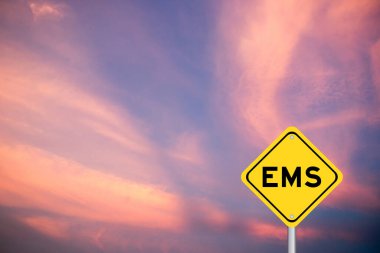 Yellow transportation sign with word EMS (abbreviation of emergency medical services or express mail service) on violet color sky background clipart