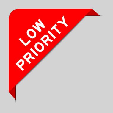 Red color of corner label banner with word low priority on gray background clipart