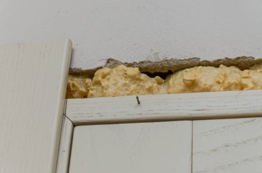 Construction mounting foam at the junction of the wall and doors