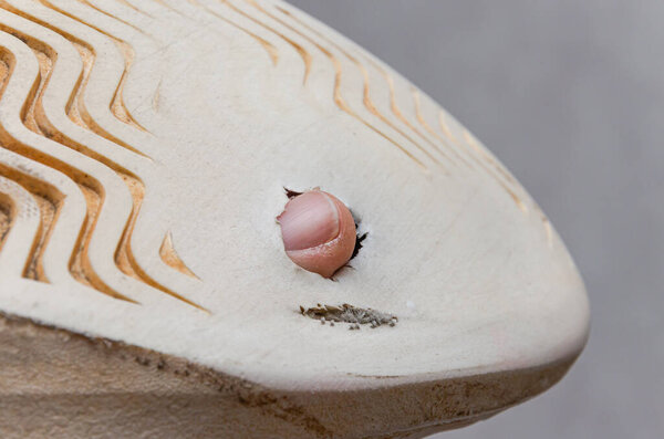 Through hole worn on the sole of sneakers