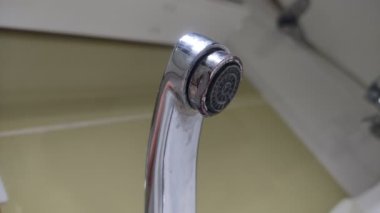 Water flows through the faucet aerator