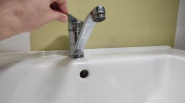 Water flows through the faucet aerator