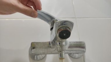Water flows through the faucet aerator