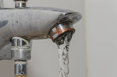 Water flows through the faucet aerator