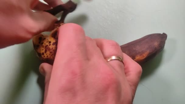Man Peels Black Sluggish Spoiled Banana Peel — Video Stock