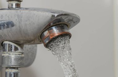 Water flows through the faucet aerator