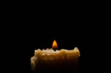 Burning flame candle isolated on black background
