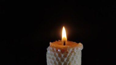 Burning flame candle isolated on black background