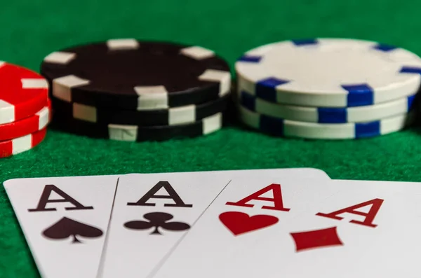 Four ace cards on the background of poker chips in a casino