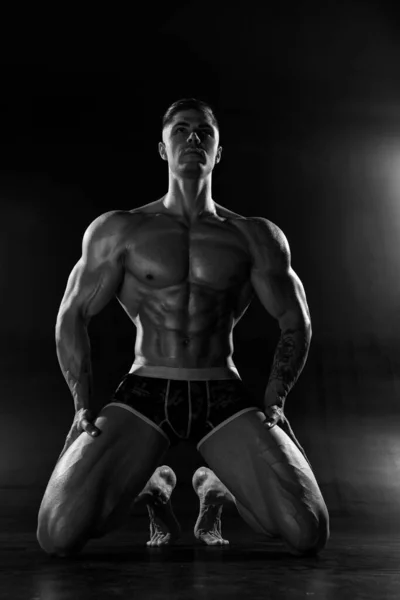 Strong Athletic Man Poses Shirtless Standing Knees Black Studio Athletic — Stock Photo, Image