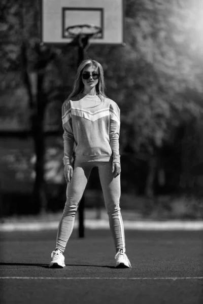 Athletic Blonde Girl Stands Basketball Court Gray Tracksuit Black White — Stock Photo, Image