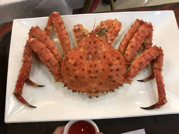 Steamed Red King Crab in a plate. Ready to eat. Top view.