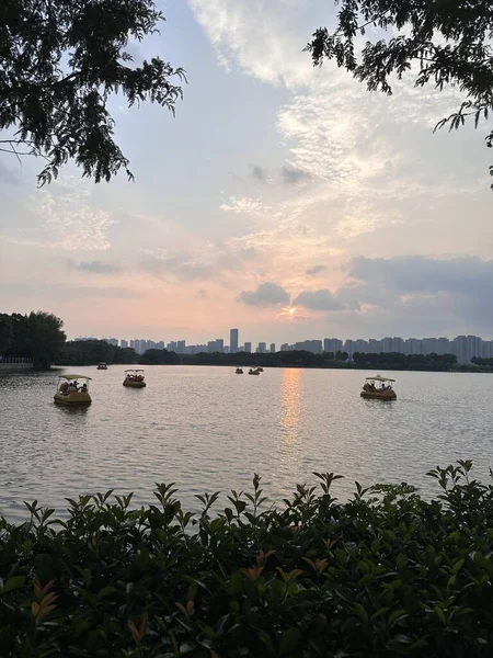 Yanghu Wetland Park, a famous tourist site in Changsha, China. Pedal boats on the lake during sunset.