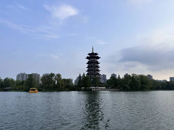 Egret Tower, A very well known and iconic symbol of Yanghu Wetland Park, a famous tourist site in Changsha, China. Lake, blue sky and reflection.